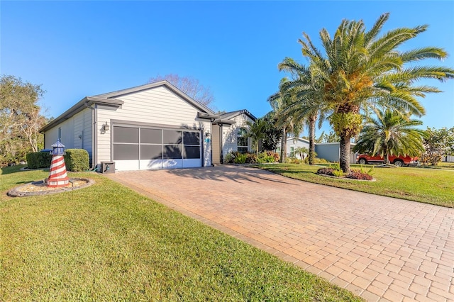 ranch-style house with a garage and a front lawn