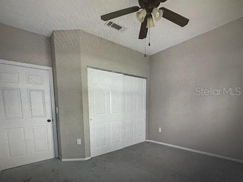 126 Vista Verdi Cir Unit 204, Lake Mary, FL 32746 - unfurnished bedroom with a closet, carpet, baseboards, ceiling fan, and visible vents