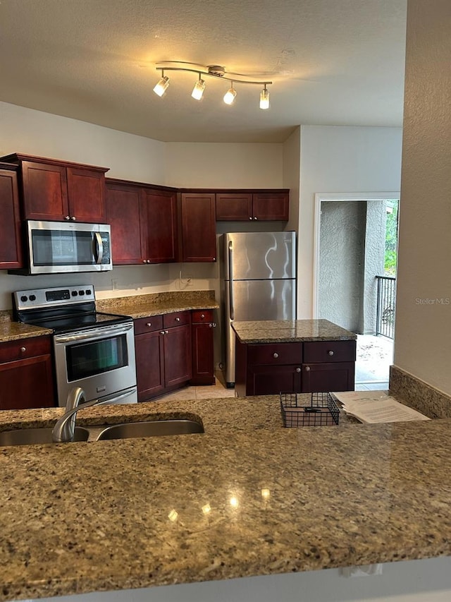 126 Vista Verdi Cir Unit 204, Lake Mary, FL 32746 - kitchen with dark brown cabinets, stainless steel appliances, dark stone countertops, and a sink