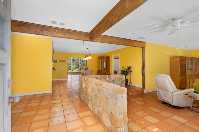 tiled living room featuring a textured ceiling, ceiling fan, and beamed ceiling