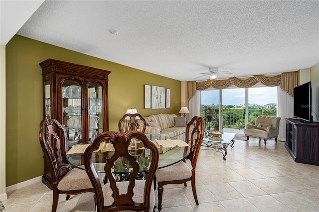 dining room with a textured ceiling, ceiling fan, and light tile patterned floors