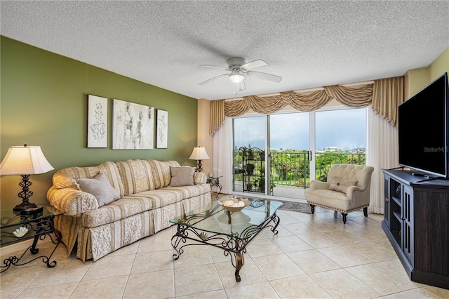 living room with light tile patterned flooring, a textured ceiling, and ceiling fan