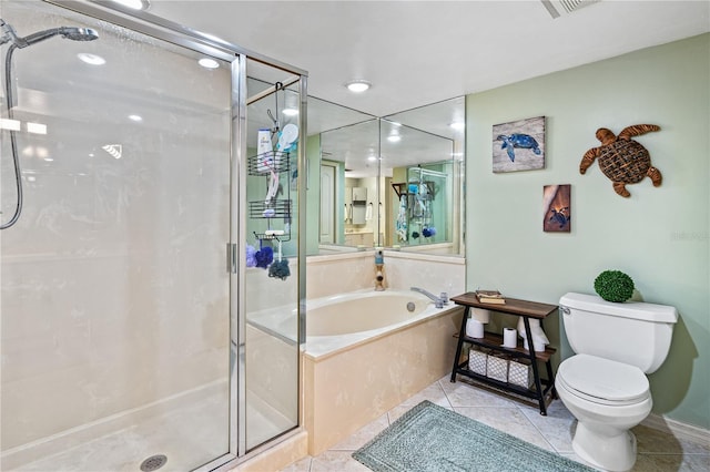 bathroom featuring toilet, tile patterned flooring, and separate shower and tub