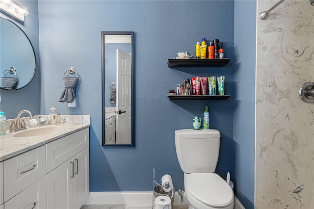 bathroom featuring toilet and vanity