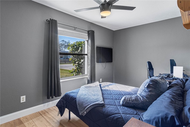 bedroom with ceiling fan and hardwood / wood-style floors