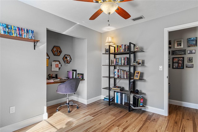 office featuring light hardwood / wood-style floors and ceiling fan