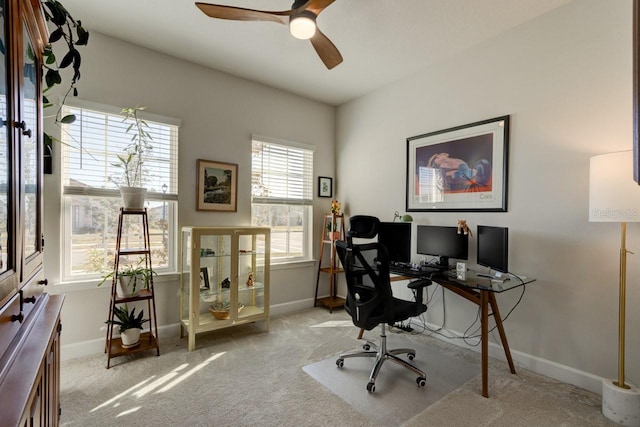 carpeted office featuring ceiling fan