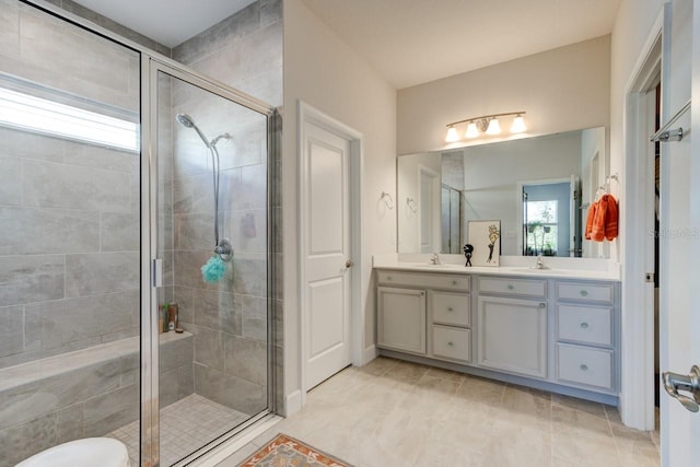 bathroom with tile patterned floors, vanity, and walk in shower