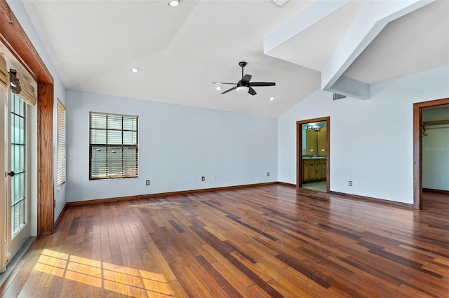 spare room featuring a healthy amount of sunlight, ceiling fan, vaulted ceiling, and wood-type flooring