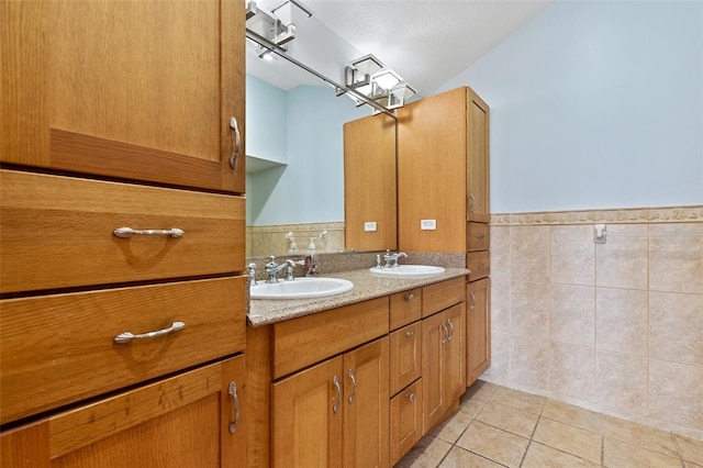 bathroom featuring tile patterned floors, vanity, and tile walls