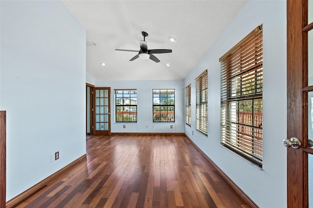 spare room with ceiling fan, dark hardwood / wood-style flooring, and vaulted ceiling