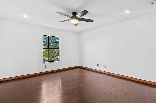 spare room with hardwood / wood-style floors and ceiling fan