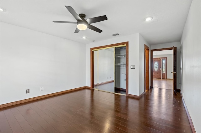 unfurnished bedroom featuring ceiling fan, a closet, and dark hardwood / wood-style floors