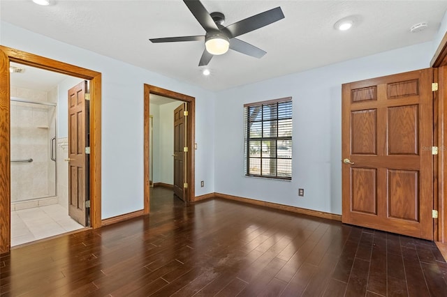 interior space featuring ceiling fan, dark wood-type flooring, and ensuite bathroom