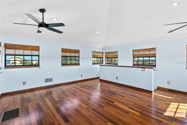 unfurnished living room with ceiling fan, vaulted ceiling, and wood-type flooring