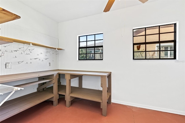 home office with a workshop area and concrete flooring