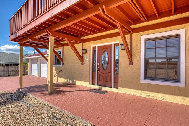 doorway to property with a balcony and a patio area