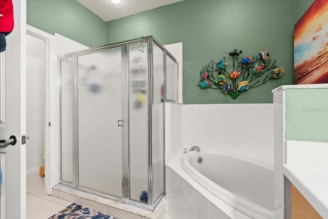 bathroom with tile patterned flooring, separate shower and tub, and a textured ceiling