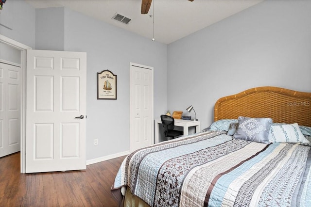 bedroom with dark hardwood / wood-style flooring, ceiling fan, a closet, and lofted ceiling