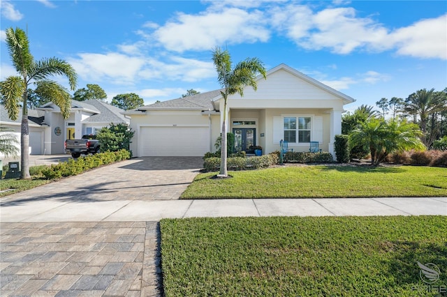 view of front of home featuring a garage and a front lawn