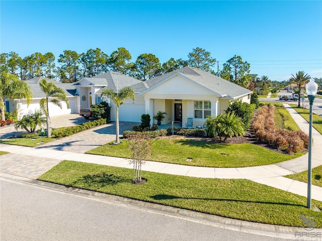 ranch-style home with a front yard and a garage