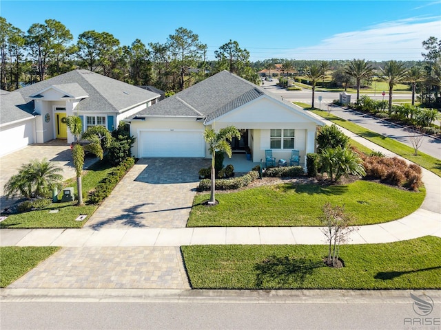 single story home with a front yard and a garage