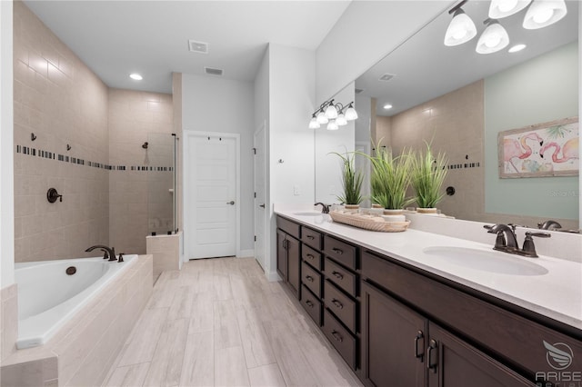 bathroom with vanity, hardwood / wood-style floors, and plus walk in shower