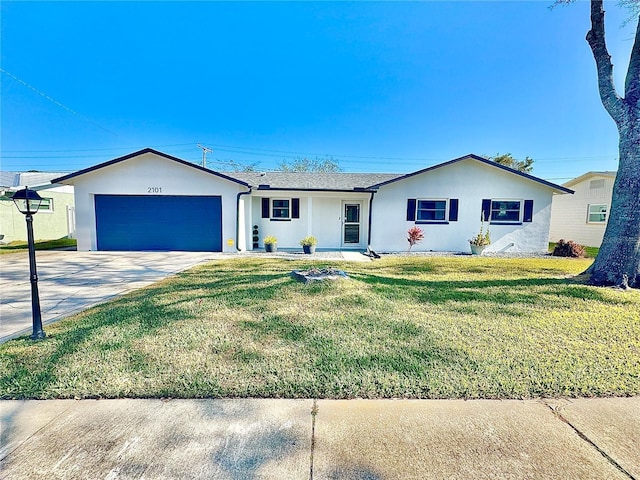 ranch-style home featuring a garage, stucco siding, driveway, and a front yard