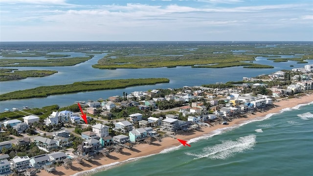 drone / aerial view featuring a view of the beach and a water view