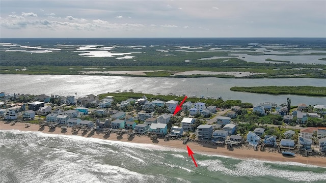 bird's eye view featuring a water view and a view of the beach