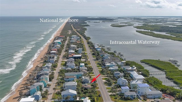 birds eye view of property featuring a water view and a view of the beach