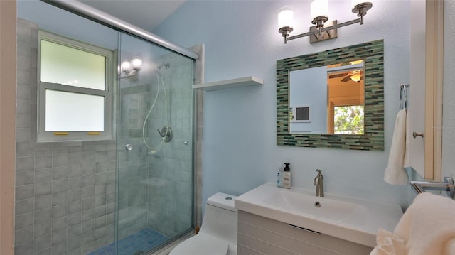 bathroom featuring vanity, an enclosed shower, and toilet