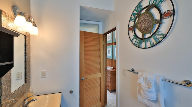 bathroom with sink and a textured ceiling