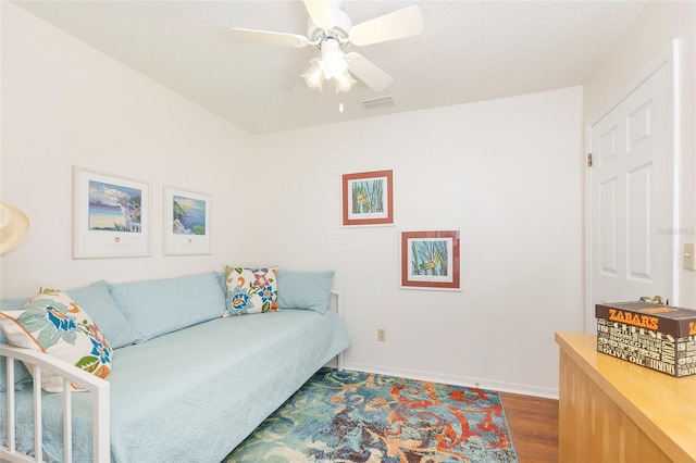 living room featuring ceiling fan and hardwood / wood-style floors