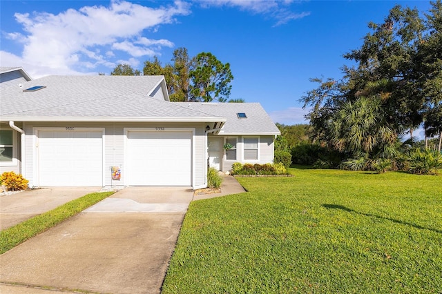 view of front of house with a front yard and a garage