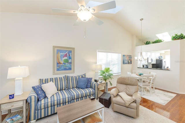 living room with high vaulted ceiling, hardwood / wood-style floors, and ceiling fan