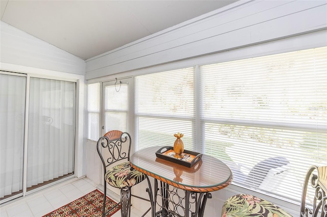 sunroom / solarium featuring lofted ceiling and a healthy amount of sunlight