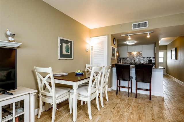 dining area with light hardwood / wood-style flooring