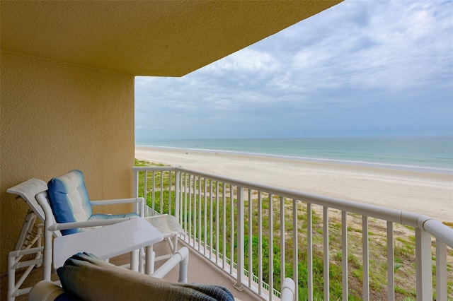 balcony featuring a water view and a view of the beach