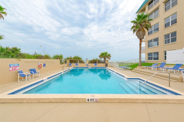 view of swimming pool with a patio