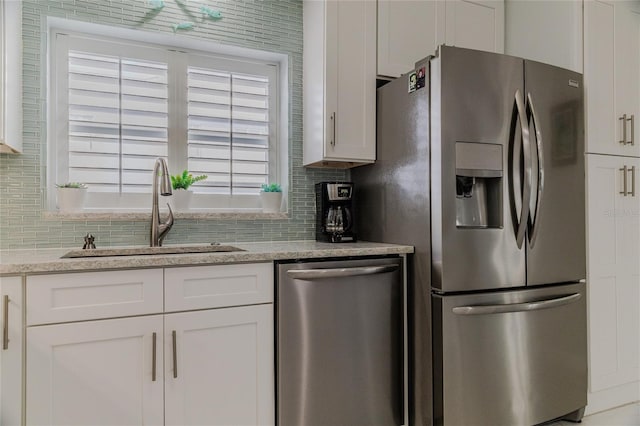 kitchen with white cabinetry, sink, and stainless steel appliances