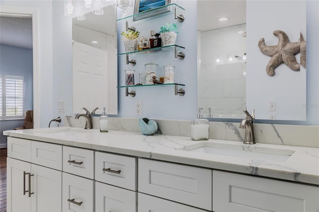 bathroom featuring hardwood / wood-style flooring, vanity, and walk in shower