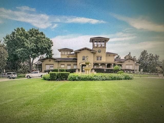 rear view of property featuring a yard