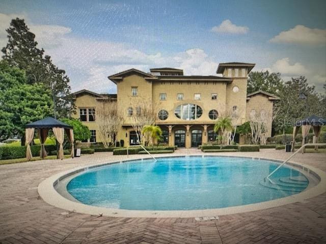 view of swimming pool featuring a gazebo and a patio