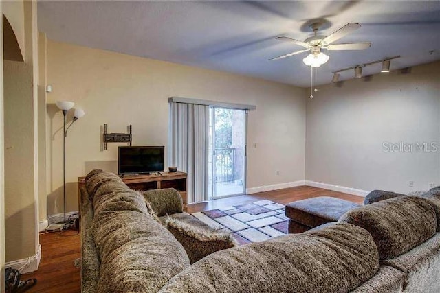 living room with ceiling fan, rail lighting, and hardwood / wood-style flooring