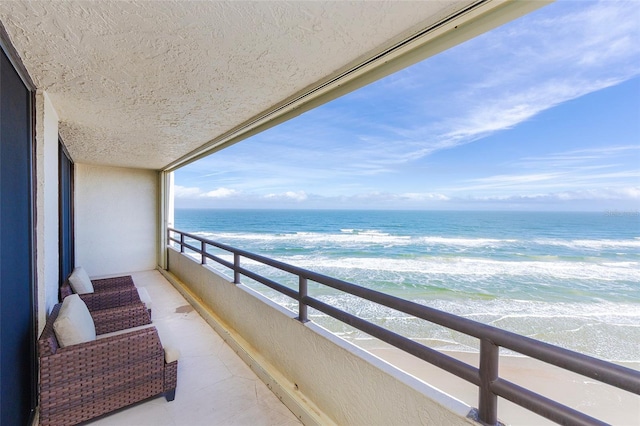 balcony with a view of the beach and a water view