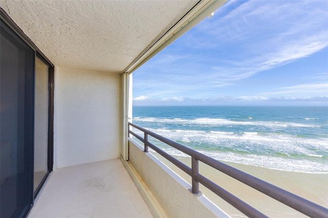 balcony with a beach view and a water view