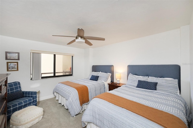 bedroom featuring ceiling fan and light carpet