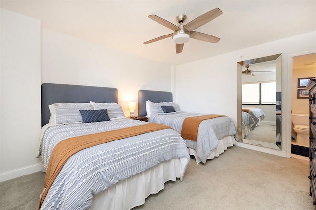 bedroom with ceiling fan, ensuite bath, and light carpet