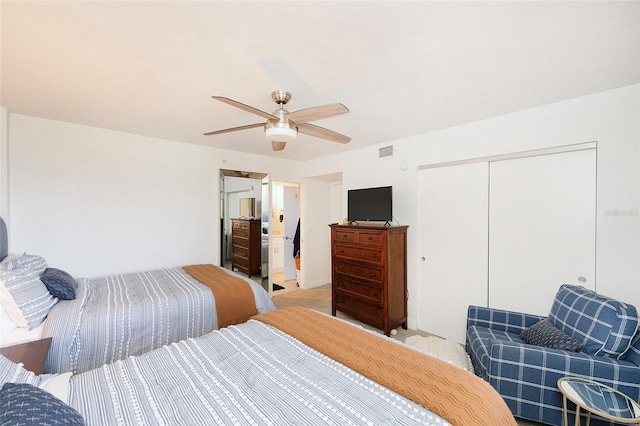 carpeted bedroom featuring ceiling fan and a closet